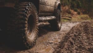 Truck driving through mud using All Terrain tires